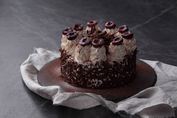 istock Chocolate fudge cake decorated with chocolate curl on black table. 953952374