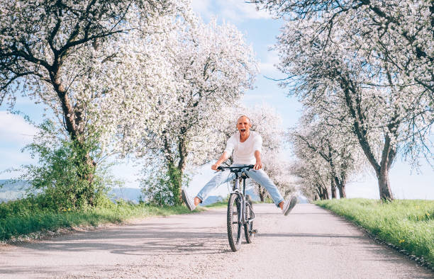 istock Man have fun when rides a bicycle on country road 953957082
