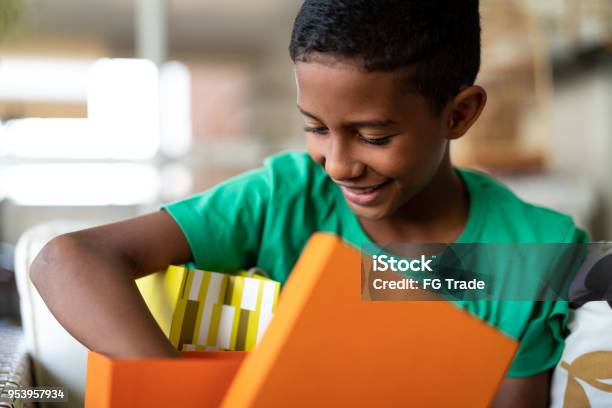 Cute Boy Opening Gifts Childrens Day Stock Photo - Download Image Now - Child, Gift, Boys