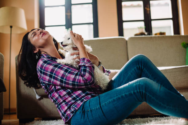 istock Woman is sitting on the floor with her dog 953961764