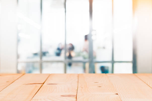 istock Empty wood table with blur abstract group of business people background 953962106