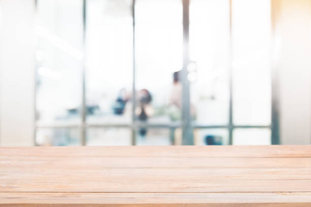 istock Empty wood table with blur abstract group of business people background 953962390