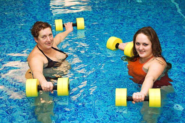 istock two womam in water with dumbbells 95396398
