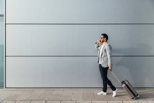 istock Man at the Airport with Suitcase 953966548