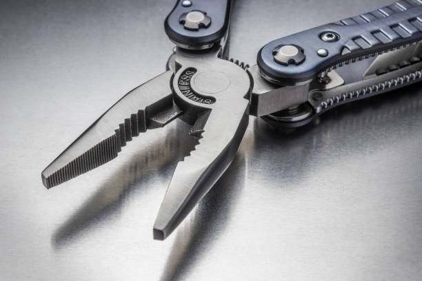 istock Metal pliers on a metallic background. 953970882