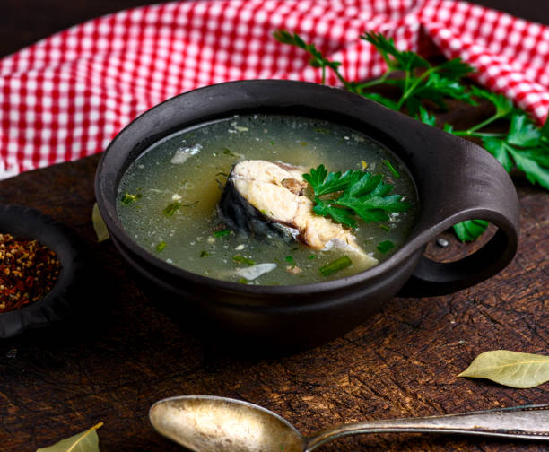 istock soup with mackerel in a brown clay plate and an iron spoon 953971584