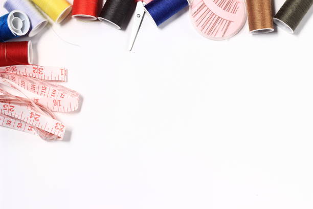 photo flat lay or top view, needle, scissor, thread, tailor meter, scissor at White Background