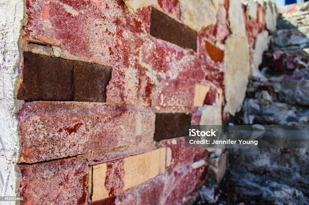 Delapidated Brick Steps Worn and dilapidated wall and stairs in color Block Shape Stock Photo