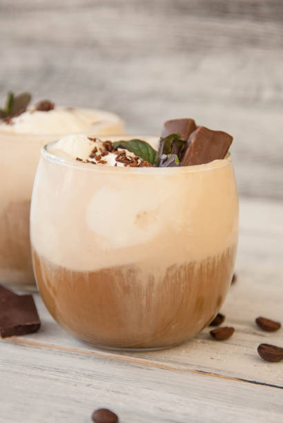 istock Iced Mocha Coffee with Whip Cream, Summer Drinking times. Coffee Beans. rustic textured Wooden Background. Mint Leaves 953980340