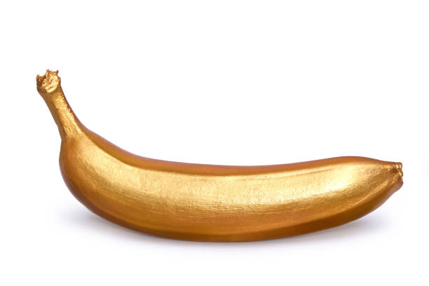 istock Golden banana isolated on a white background. Creative concept with fruit. 953980858