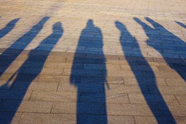 istock People shadows on the pavement 953986118