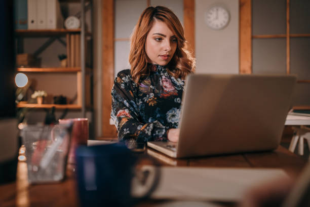 istock Woman working in office at night 953986356