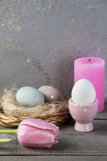 istock Eggs and rose aroma candle on old wooden background 953995848