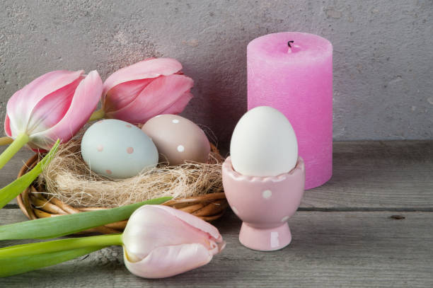 istock Eggs and rose aroma candle on old wooden background 953996174