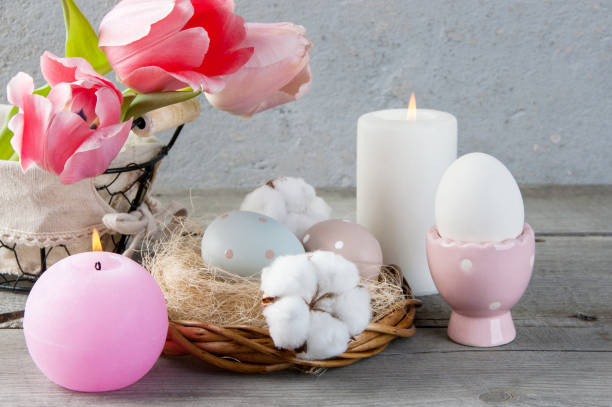 istock Eggs and aroma candles on old wooden background 953996334