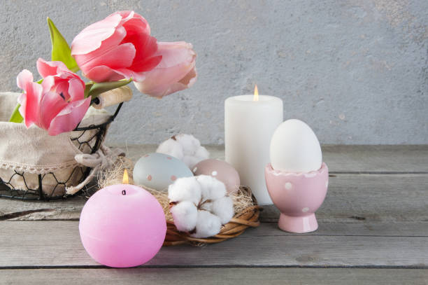 istock Eggs and rose aroma candle on old wooden background 953998686