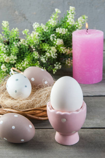 istock Eggs and rose aroma candle on old wooden background 953998740