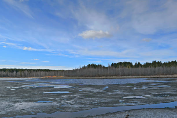istock early spring, ice melts on the lake 953999328