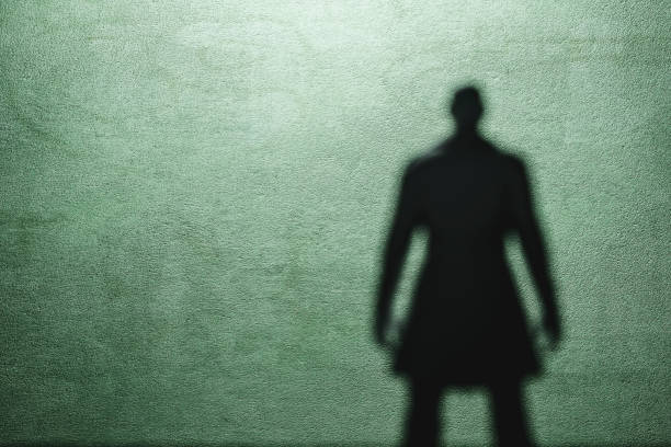 Shadow of a spooky man in trench coat Shadow of a spooky man in trench coat. creepy stalker stock pictures, royalty-free photos & images