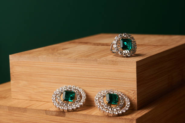 istock Emerald ring and pair of diamond earrings in gold 954006758