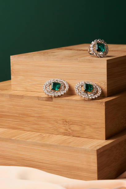 istock Emerald ring and pair of diamond earrings in gold 954007582