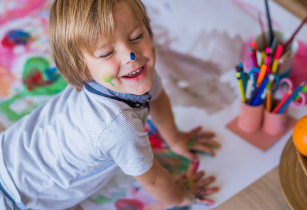 istock Little boy with colorful hands 954007610