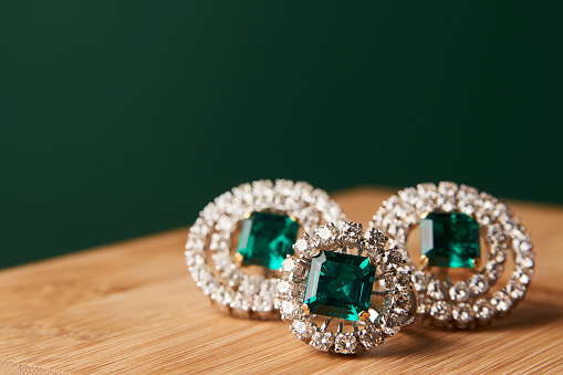 istock Emerald ring and pair of diamond earrings in gold 954008138
