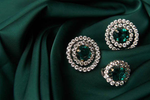 istock Emerald ring and pair of diamond earrings in gold 954009228