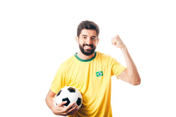 istock Brazilian soccer player celebrates on white background 954011390