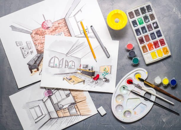 istock Creative profession: designer's desk with scattered sketches, paints, brushes, liner, pencil. 954012264