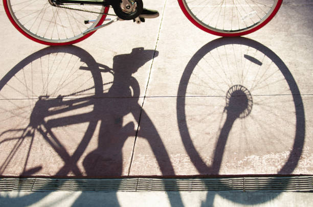 istock Shadow of a Bicycle on Pink Sidewalk 954016478