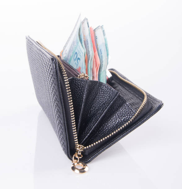 istock wallet. woman wallet with money on background 954018842