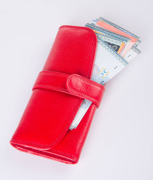 istock wallet. woman wallet with money on background 954018872