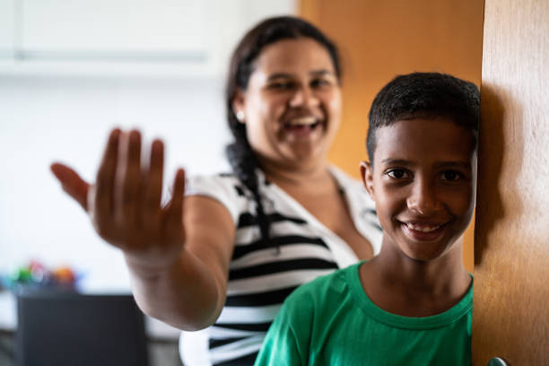 Mother and son welcoming and opening door Welcome to my house beckoning stock pictures, royalty-free photos & images