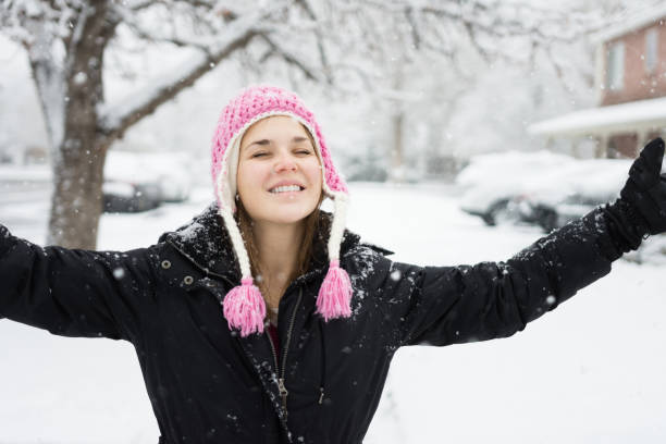 istock Young woman smiling in the snow 954026548