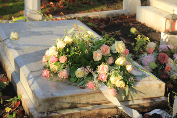 istock Funeral flowers on a tomb 954034020
