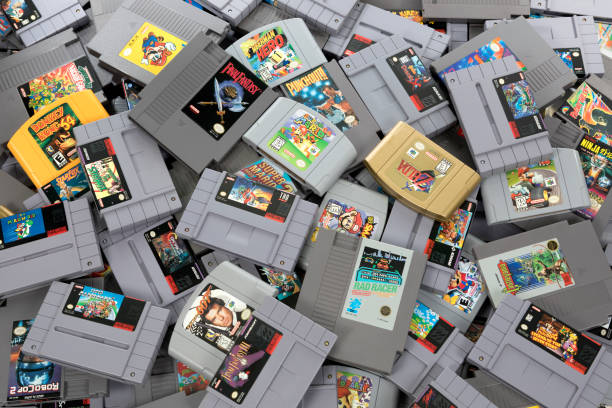 Retro Video Game Cartridge Collection Taipei, Taiwan - February 20, 2018: A studio shot of a heap of retro video games shot from above. cartridge stock pictures, royalty-free photos & images