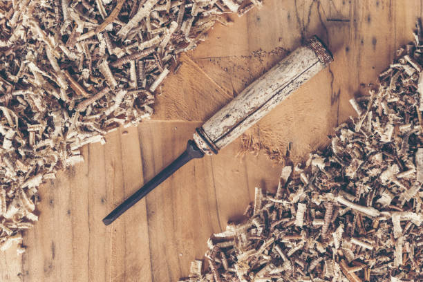 Carpenter tools on wooden table with sawdust. Carpenter workplace top view