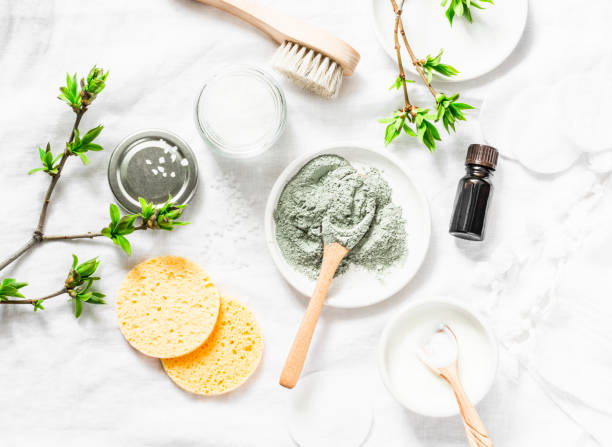 istock Dead sea mud mask - beauty products ingredients on light background, top view. Beauty concept. Flat lay 954046822