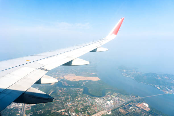 istock Aircraft Wing Look at view with cloud sky 954047490