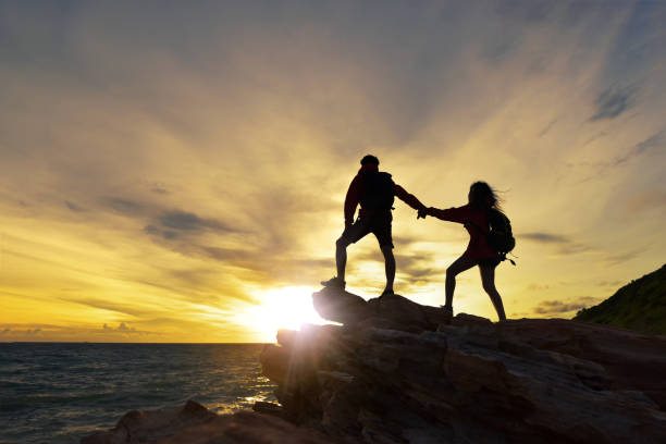 istock Young asian couple climbing. 954051148