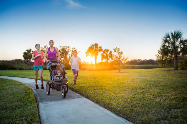 istock Family jogging and exercising outdoors together 954052224