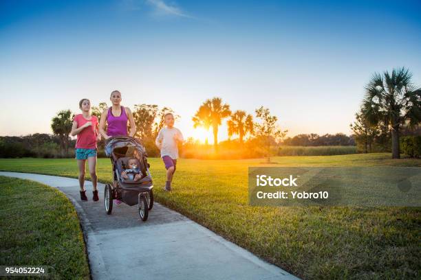 Family Jogging And Exercising Outdoors Together Stock Photo - Download Image Now - Family, Public Park, Exercising