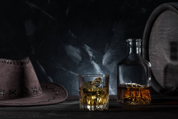 istock Transparent glass with whiskey cowboy hat and decanter 954056184