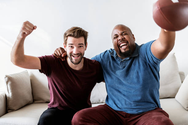 istock Men cheering sport together 954056528