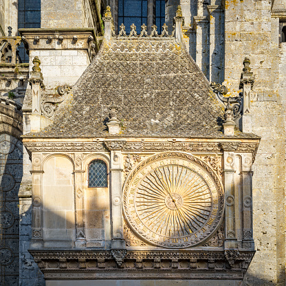 Chartres, France - May 21, 2017: Ancient astronomical clock on  North facade of Cathedral of Our Lady of Chartres
