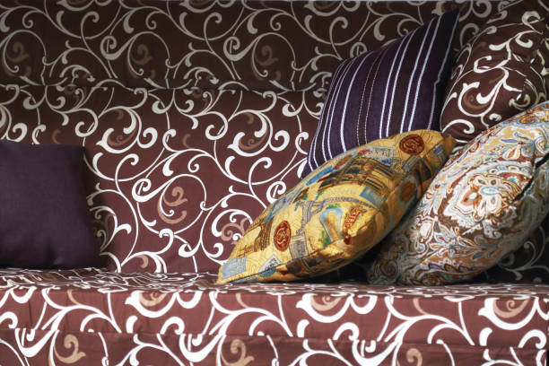istock Pillows for rest on the summer garden swing brown. 954060548