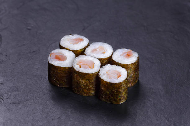 istock Traditional sushi rolls with redfish served on black slate, Japa 954061294