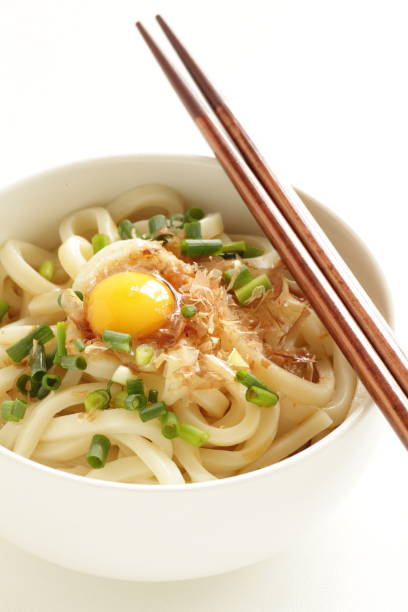 istock raw quail egg and fish flake on Udon noodles 954061690