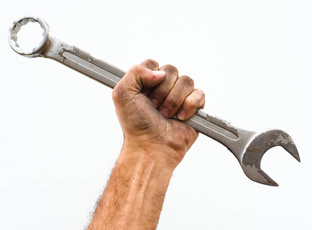 Workers hand and wrench. stock photo